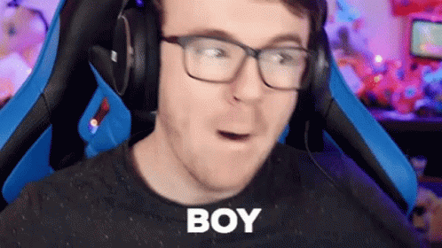 Man With Glasses and Headphones in Gaming Chair Making Funny Face