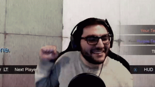 Man with Glasses and Headphones Playing Video Game