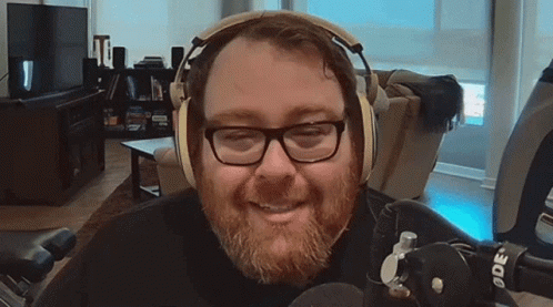 Man with Glasses and Headphones Smiling