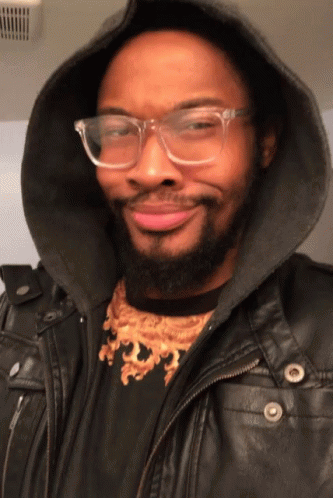 Man With Glasses and Hooded Jacket Smiling