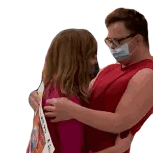 Man with Glasses and Mask Hugging Woman