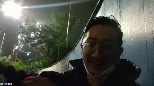 Man With Glasses and Mask Smiling Near 1282 Wall