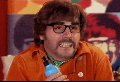 Man With Glasses and Mustache Holding Blue Bottle