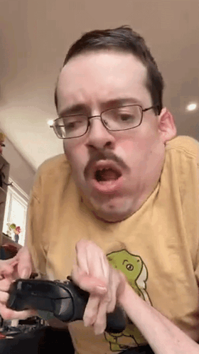 Man With Glasses And Mustache Holding Controller Funny Face GIF