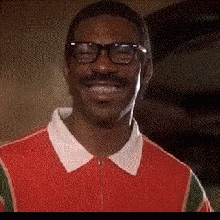 Man with Glasses and Mustache Smiling in Red Shirt
