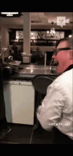 Man With Glasses and Pink Mask at Counter