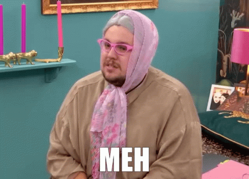 Man With Glasses And Pink Scarf Saying Meh On Shirt GIF