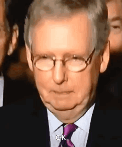 Man with Glasses and Purple Tie Making Face