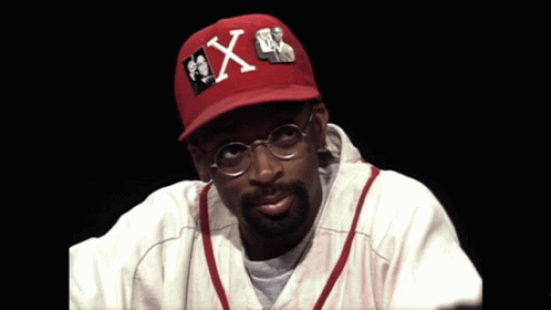 Man With Glasses and Red Hat With Letter X