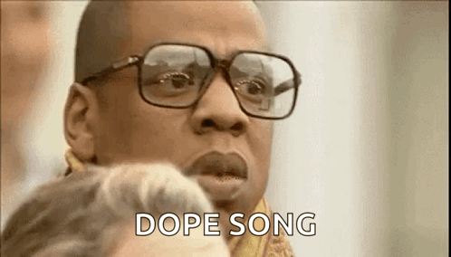 Man With Glasses And Scarf Talking To Woman GIF