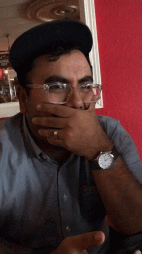 Man With Glasses and Watch Covering Mouth