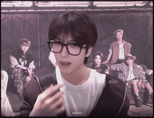 Man with Glasses and White Shirt Saying NCT Dream