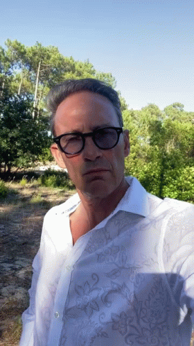 Man with Glasses and White Shirt Taking Selfie