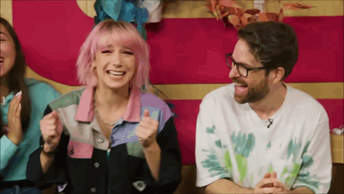 Man With Glasses and Woman With Pink Hair Laughing