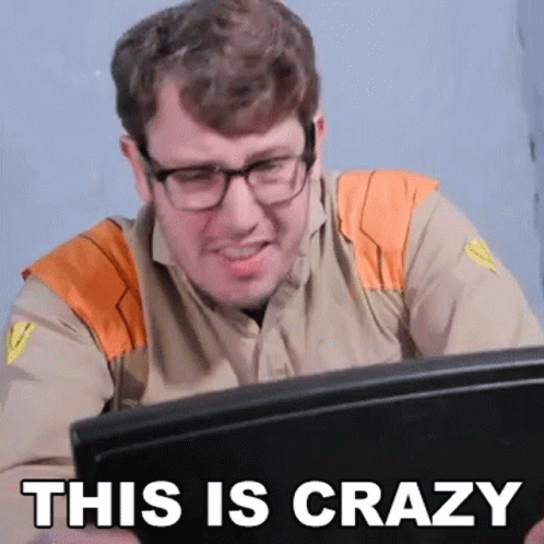 Man With Glasses at Laptop Says This Is Crazy