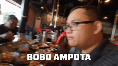 Man With Glasses At Table With Food Saying Bobo Ampota GIF