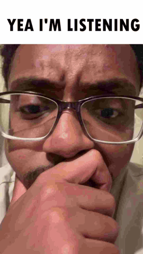 Man With Glasses Covering Mouth Making Funny Face