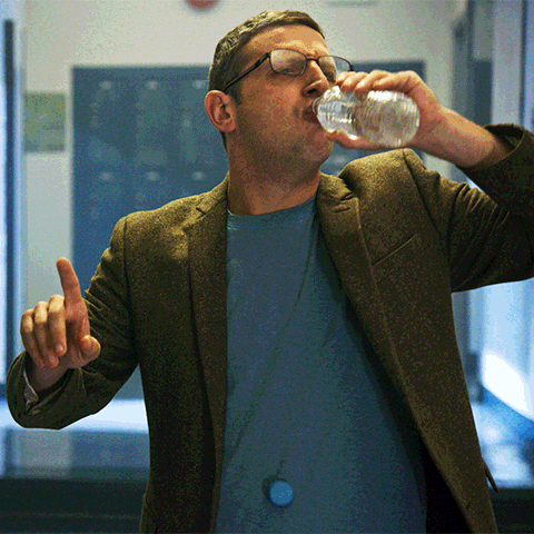 Man With Glasses Drinking From Bottle