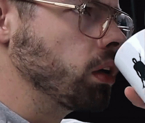 Man With Glasses Drinking From Cup With Silhouette