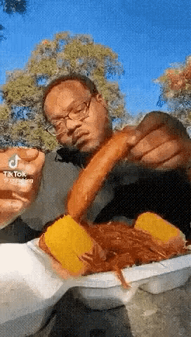 Man With Glasses Eating Hot Dog