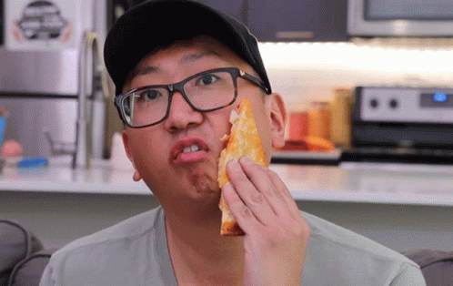 Man with Glasses Eating Pizza