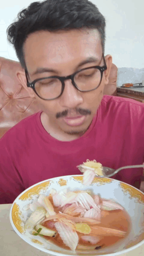 Man With Glasses Eating Soup With Fork