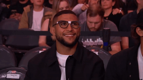 Man With Glasses Giving Peace Sign Watching UFC Fight