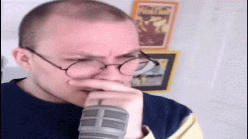 Man With Glasses Hand to Mouth