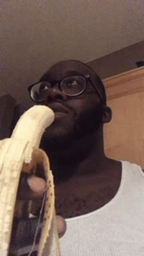 Man With Glasses Holding Banana In Mouth GIF