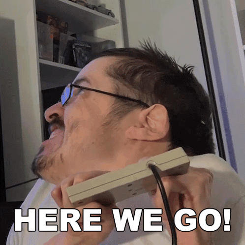 Man With Glasses Holding Controller Saying Here We Go
