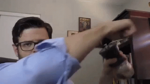Man With Glasses Holding Gun