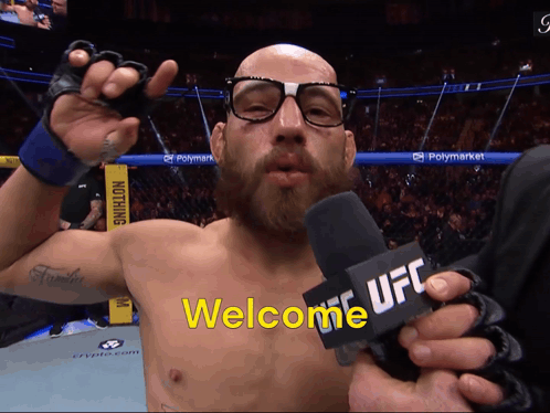 Man With Glasses Holding Microphone Saying Welcome UFC