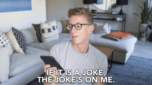 Man With Glasses Holding Phone Saying Joke's On Me