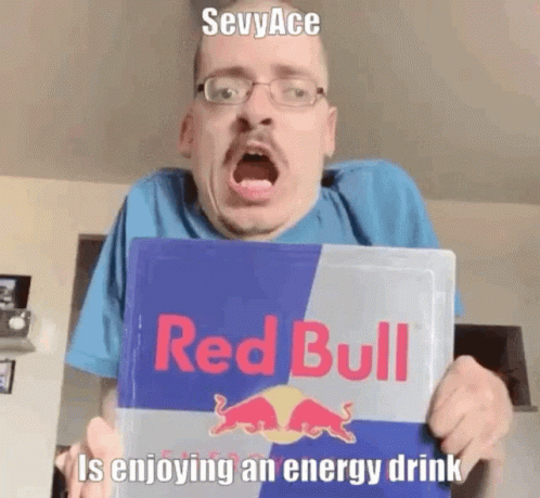 Man With Glasses Holding Red Bull Sign