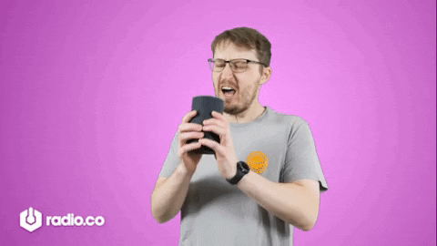 Man With Glasses Holding Speaker In Front of Purple Background Saying Radio.co