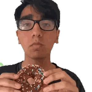 Man With Glasses Holding Sprinkled Donut
