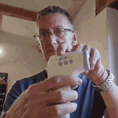 Man With Glasses Holding Thermometer