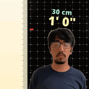 Man With Glasses in Front of Ruler Saying 30 cm