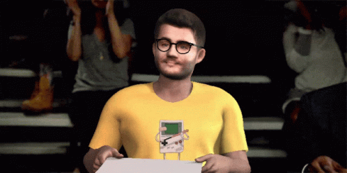 Man With Glasses in Yellow Shirt With Game Boy