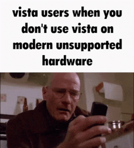 Man With Glasses Looking At Cell Phone Saying Vista Users When You Don't Use Vista On Modern Unsupported GIF