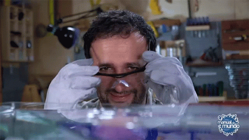 Man With Glasses Looking Through Magnifying Glass Manual El Mundo GIF