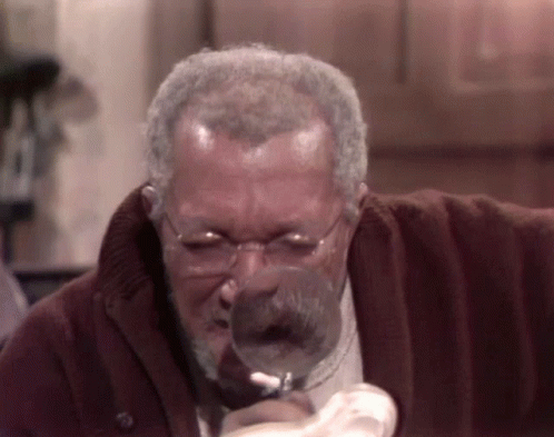 Man with Glasses Looking Through Magnifying Glass