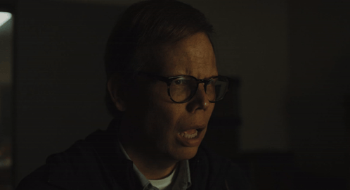 Man with Glasses Making Funny Face in Dark
