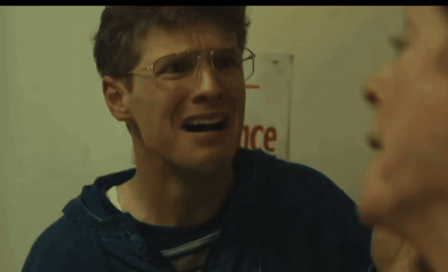 Man With Glasses Making Funny Face in Front of Ance Sign