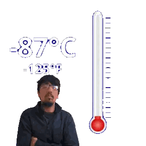 Man with Glasses Next to -87°C Thermometer