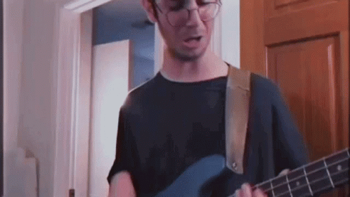 Man With Glasses Playing Blue Guitar