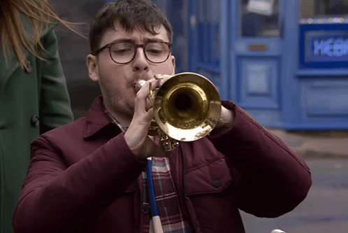 Man With Glasses Playing Trumpet at Blue Door Picker