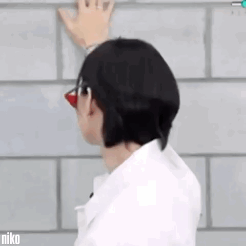 Man with Glasses Red Nose Hand on Brick Wall