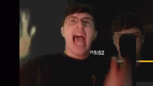 Man With Glasses Screaming in Dark Room
