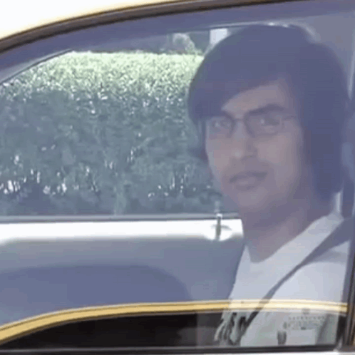 Man With Glasses Sitting in Car